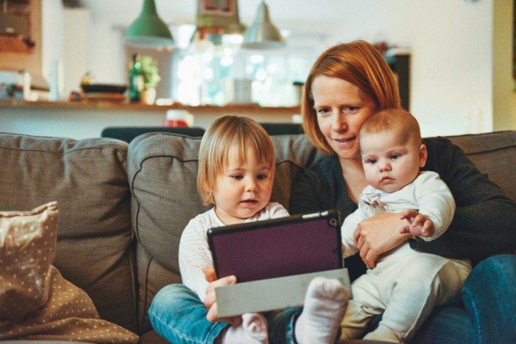 Двое младенцев и женщина смотрят YouTube на iPad